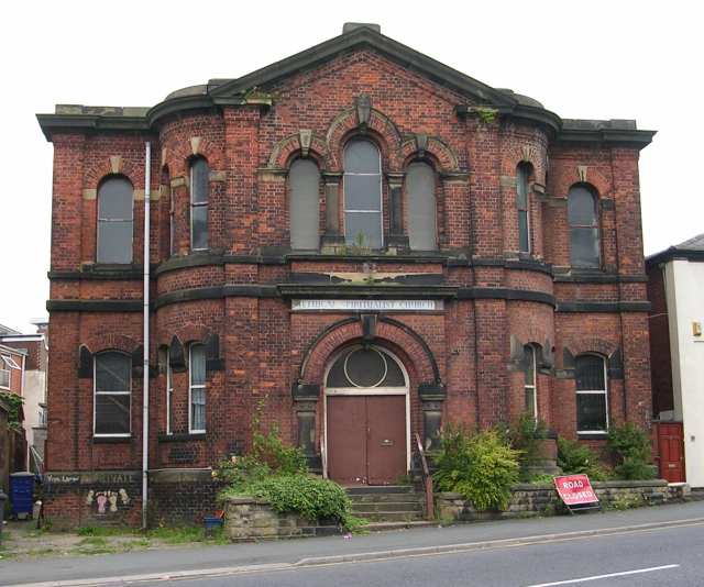 A derelict red brick church building on Lime Street, illustrating the concept of urban decay and potential conflicts of.